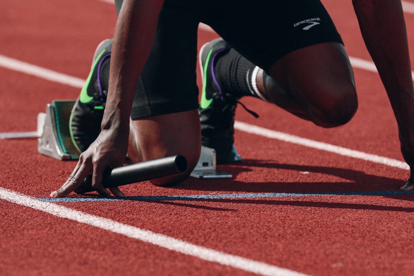 A sprinter driving out of the blocks during athletics training