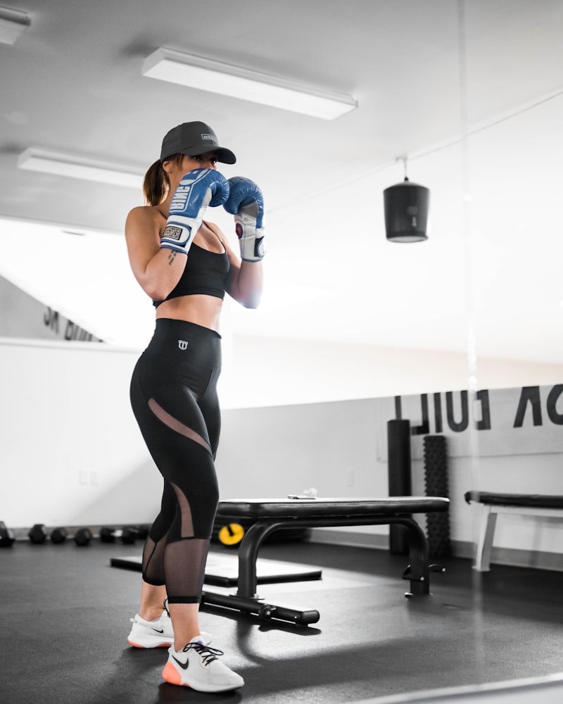 Boxing coach at Team Alpha in Bowenpally wearing gloves