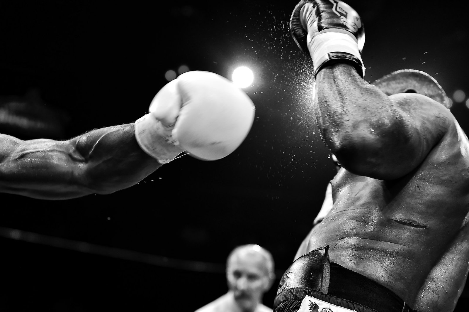 Black-and-white shot of a boxer mid-punch at Team Alpha